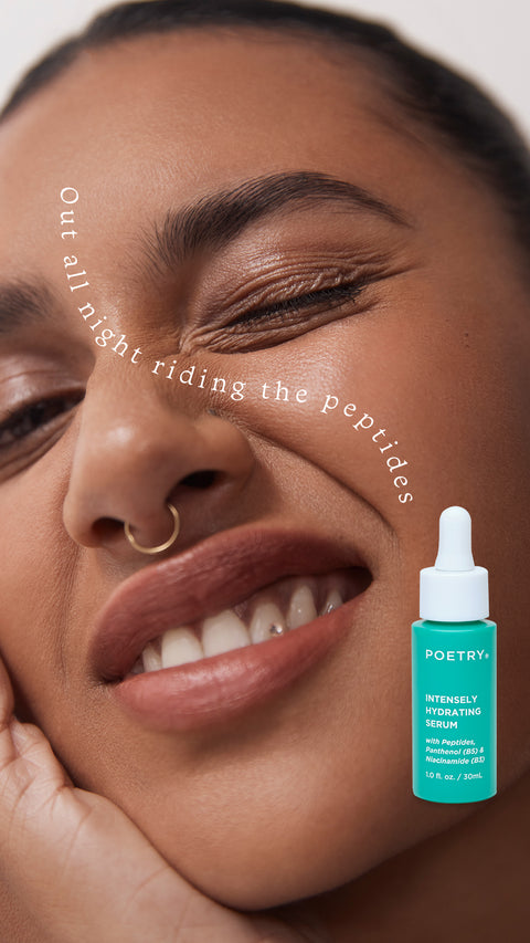 Woman with brown hair back, brown eyes, brown skin, nose ring, resting her hand against the side of her face, winkingg at the camera. Writing  that says Out all night riding the peptides travels down from bewteen her eyebrows, down her nose across her cheek. 